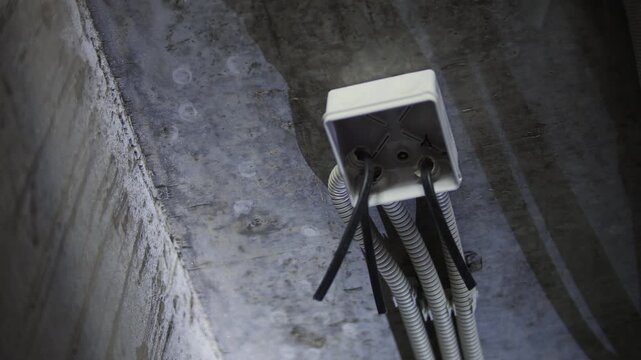 Electrical junction box with conduits mounted on concrete ceiling