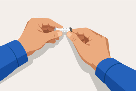 Hands holding a wall plug for mounting objects and home improvement