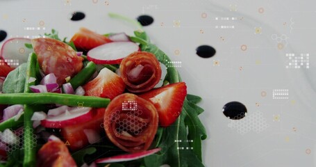 Displaying salad resting on white plate in studio, with greens, strawberries, prosciutto, balsamic © vectorfusionart