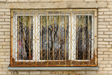 old window with rusty ornamental cast iron fence of a soviet apartment block  © Kristof Lauwers