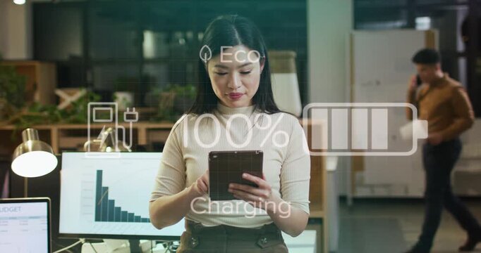 Woman tapping tablet causing faint battery HUD charging to full then dropping, IT peer walking by