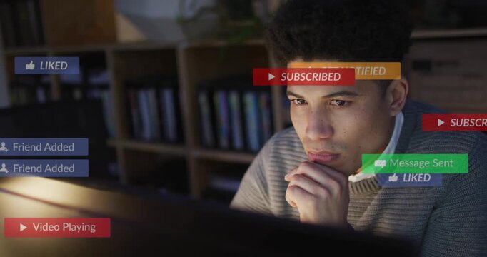Man sitting desk viewing monitor, new social media alerts grouping near face, fading tracking likes
