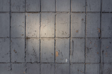 Old and shabby tiles in the sun rays