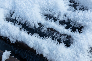 Iron sewer grate with ice crystals from high humidity