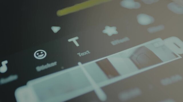 Finger selects the option Text in a video editing application