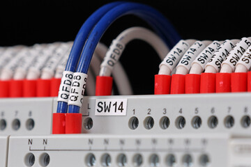 Marking electrical wiring wires with thermally printed nylon tape. 