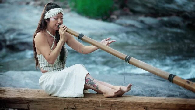 A serene moment captured: a woman playing a traditional bamboo Instrument didgeridoo by a river, surrounded by nature, harmonizing with the soothing sounds of flowing water.