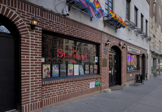 The Stonewall Inn sign next to entrance to iconic LGBTQ gay bar nightclub in Greenwhich Village, Manhattan, New York City, USA.