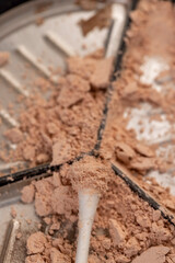 Fototapeta premium old scattered broken cosmetics, makeup powder , dust and small and large pieces of women's cosmetics that were broken