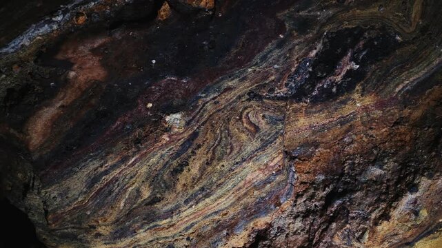 Rainbow Cave on Hormuz Island, Iran, showcasing naturally colorful rock formations and mineral layers. Unique geological landscape, natural wonder, travel destination, earth textures, vibrant colors, 