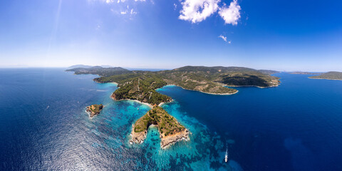 Epic Aerial 16K Panorama of Kokkinokastro Whale Tail Rock with Yacht &mdash; Massive Orange Cliffs and Tiny Boat for Scale, Alonissos Marine Park Greece Sporades islands