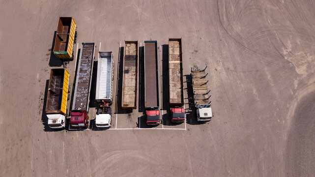 trucks stand in a row Parking lot - top view from the drone