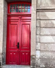 Red wooden door on stone wall background