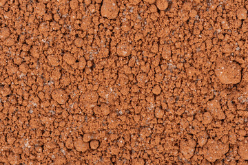 Close up macro texture of dry hot cocoa chocolate mixture with small granules of sugar