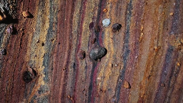 Rainbow Cave on Hormuz Island, Iran, showcasing naturally colorful rock formations and mineral layers. Unique geological landscape, natural wonder, travel destination, earth textures, vibrant colors, 