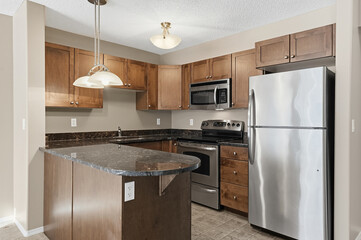 Kitchen with a stainless steel refrigerator, microwave, and oven