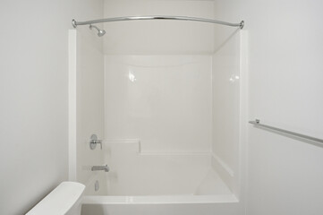 White bathroom with a bathtub and a shower