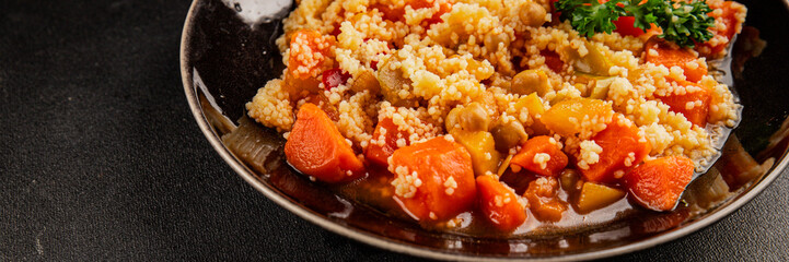 Couscous with vegetables carrots, chickpea, zucchini, turnip, pepper, celery, pumpkin tasty snack fresh gourmet food background on the table rustic food top view copy space keto and paleo 