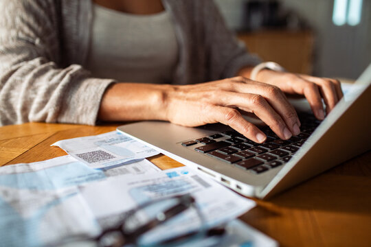 Woman paying bills online at home