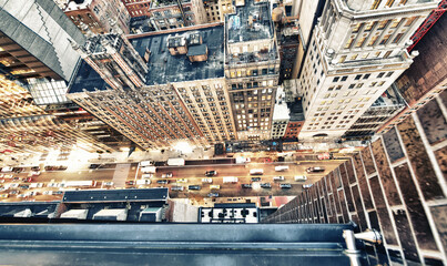 Amazing skyscrapers in Midtown Manhattan, aerial view from rooftop with traffic reflections on the buildings at night © jovannig