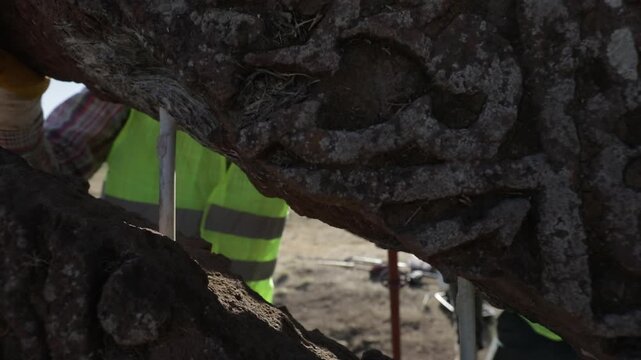 Expert restorers using metal pins and specialized techniques to rejoin fragments of a historical Seljuk tombstone in Ahlat, Turkey.
