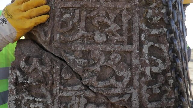 Expert restorers using metal pins and specialized techniques to rejoin fragments of a historical Seljuk tombstone in Ahlat, Bitlis.