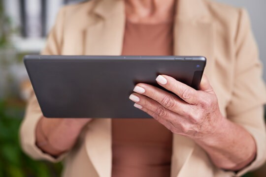 Business Professional Using Tablet Device in Modern Office Setting for Work, Communication, and Productivity