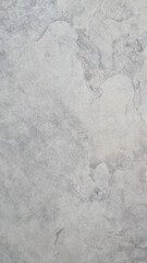 Obraz premium A smooth, light gray surface with subtle variations in texture. The material appears polished and uniform, suitable for modern design applications. copy space