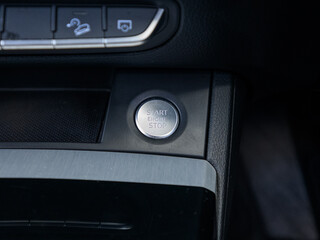 Naklejka premium Car engine start stop button on modern vehicle dashboard