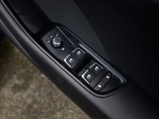 Obraz premium Car door window controls and mirror adjustment buttons close up