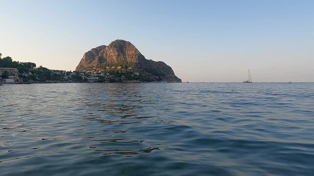 Calm mediterranean scene at Kafara Beach with gentle waves. Santa Flavia, Italy