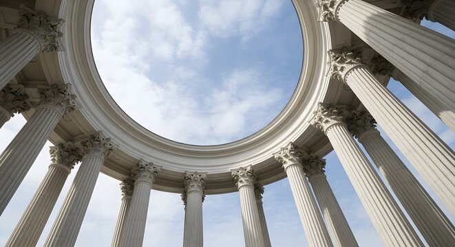 Majestic architectural columns reaching towards a clear blue sky with scattered clouds