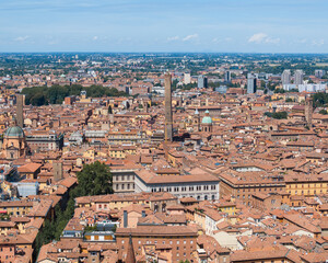 Aerial view of Bologna city skyline with Asinelli Tower under blue sky, Italy