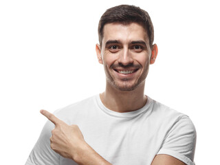Naklejka premium Happy man in casual white tee pointing sideways with finger while smiling at camera