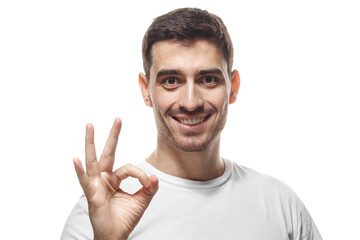 Smiling man showing okay sign with fingers expressing approval and positive gesture