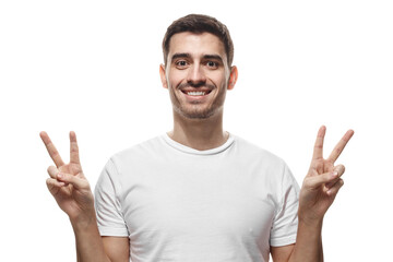 Fototapeta premium Happy man showing peace victory signs with both hands and smiling at camera