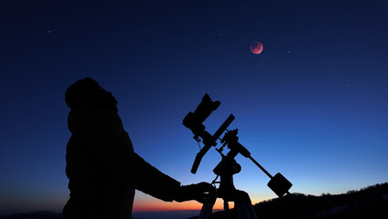 Amateur astronomer observing stars, planets, Moon eclipse and other celestial objects. © astrosystem