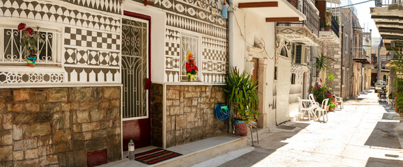 Pyrgi Village Chios Ultra-Wide Panorama: Traditional Houses with Geometric Xysta Wall Paintings and Floral Decor, Empty Sunny Street of Painted Village, Mediterranean Aesthetics Greece 9K High Res