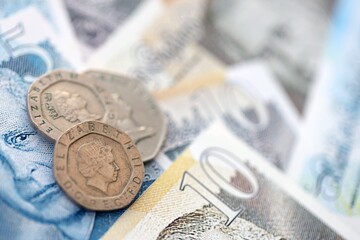 Coins and banknotes of United Kingdom and Great Britain pound currency. UK money close up....