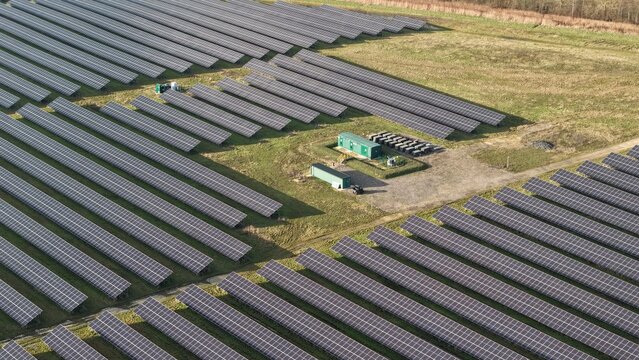 Aerial view of the Sutton Bridge Solar power station, where rows of solar panels stretch across the landscape, contrasting with the green service buildings, Sutton Bridge, United Kingdom.