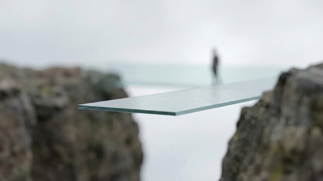 崖の間に架かる透明なガラス橋の緊張感