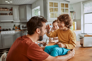 Fototapeta premium Happy family breakfast in cozy home kitchen