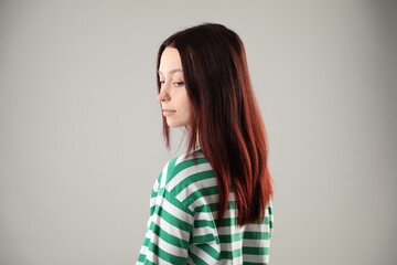 Fototapeta premium Woman with color dyed hair on light grey background
