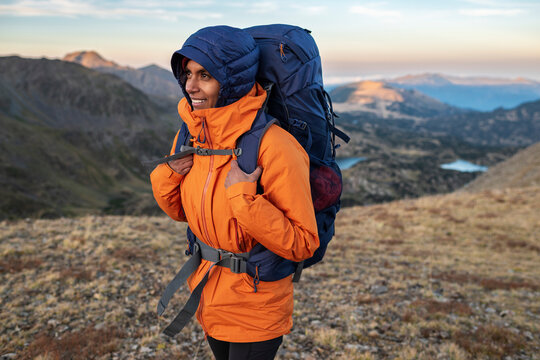 Focused female adventurer embracing solitude during mountain journey