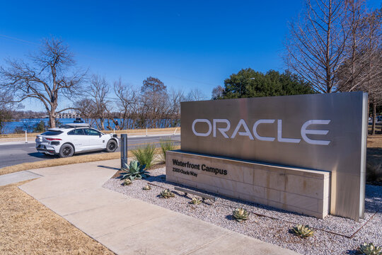 Austin, TX - 5 February 2026: Oracle Waterfront Campus building alongside Lady Bird Lake with Waymo driverless car