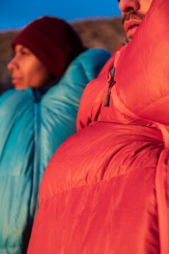 Close view of hikers sharing quiet sunrise moment in mountains