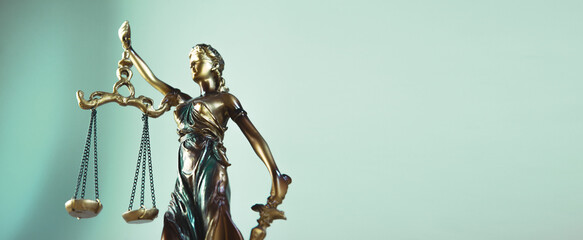 Statue of justice with scales of justice in a courtroom or law enforcement office