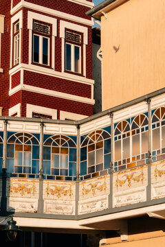 Ornamental window and brick wall under evening sun