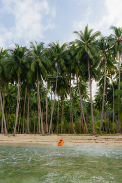 Kayak on the pristine white sand beach surrounded by coconut grove 