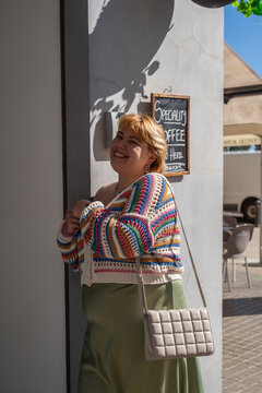 Portrait of happy woman at cafe doors